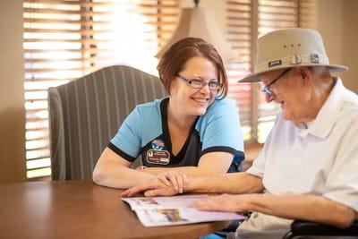 Staff member engaging with a resident at a table