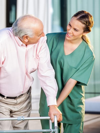 Emerald Nursing & Rehab Omaha, Nursing Home in Omaha, NE — Senior caregiver assisting an elderly man with a walker