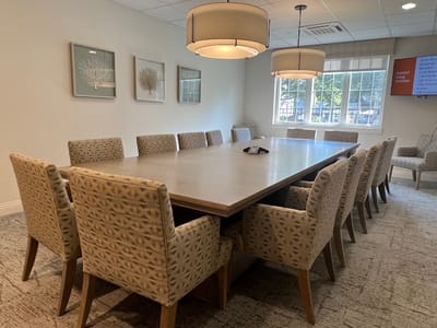Bright interior conference room with large table and chairs