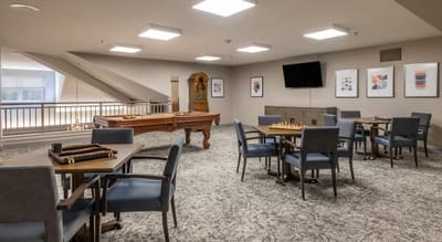 Bright common area with a pool table and seating