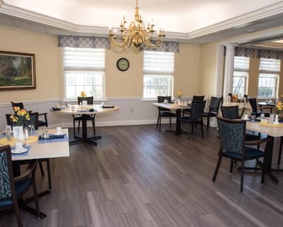 Dining room with set tables and floral arrangements