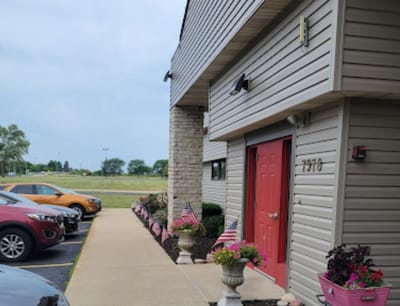 Exterior view of a senior care facility entrance with flowers