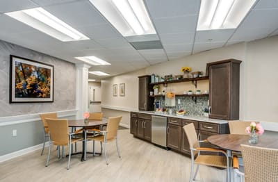 Interior view of a dining area with tables and kitchenette
