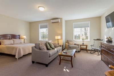 Cozy resident room with seating and natural light