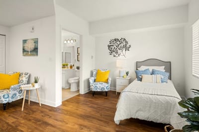 Brightly decorated resident room with cozy furnishings