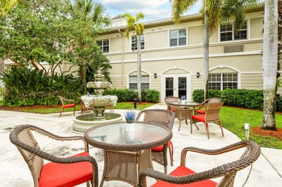 Outdoor seating area with fountain and greenery