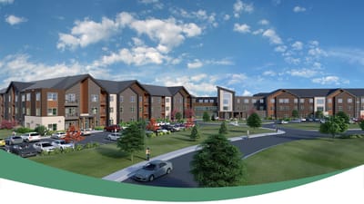 Exterior view of a senior living community with landscaped grounds