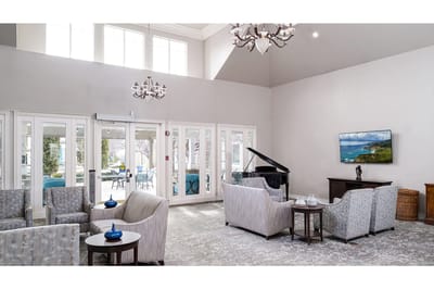 Bright common area with seating and a piano