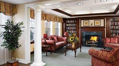 Cozy common area with bookshelves and a fireplace