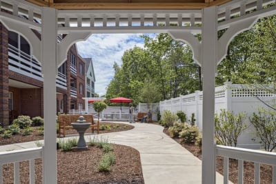 Pathway in a garden area with seating and trees