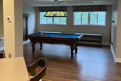 A pool table in a well-lit common area