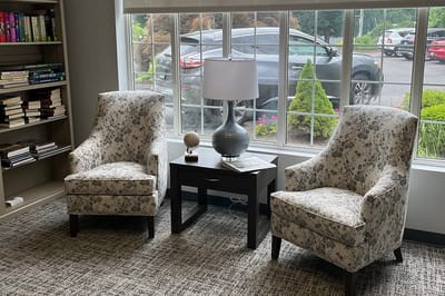 Cozy seating area with floral chairs and lamp