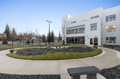 Outdoor courtyard with benches and landscaping