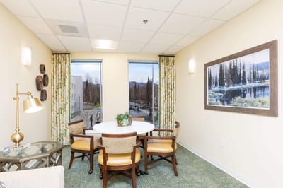 Brightly lit interior space with a table and chairs