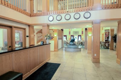Bright lobby area with decorative clock wall and fountain