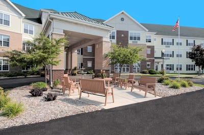 Outdoor seating area in front of a senior living facility