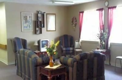 Cozy common area with seating and floral arrangement