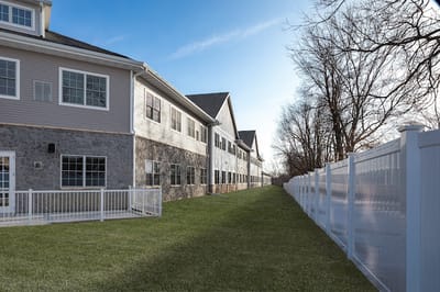 Exterior view of a senior living facility with landscaped area