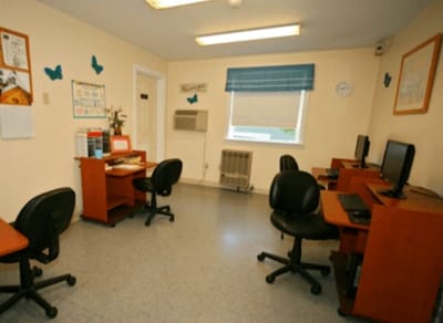 An interior room with computers and furniture