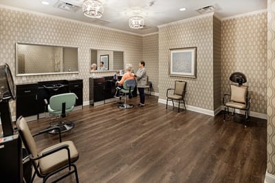 Resident receiving a hair treatment in a salon