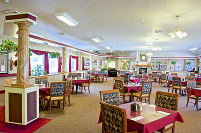 Bright dining room with floral chairs and tables