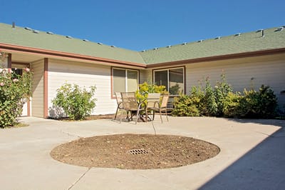 Outdoor patio area with seating and landscaping