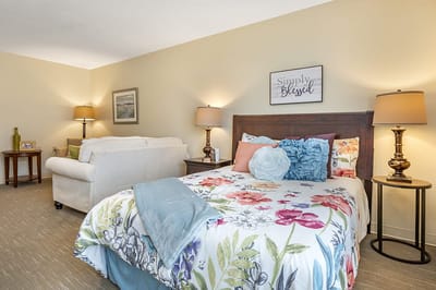 Cozy bedroom setup with floral bedding and warm lighting