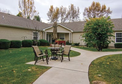 Outdoor seating area with a pathway and trees