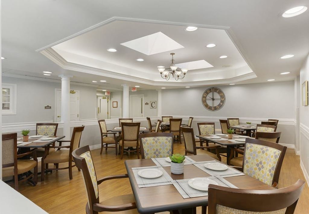 Dining area with tables and chairs in a well-lit room