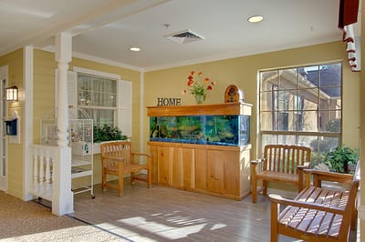 Bright common area with an aquarium and seating