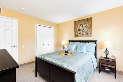 Cozy bedroom with a queen bed and artwork