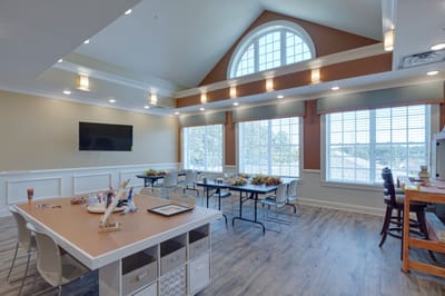 Bright interior room with large windows and seating areas