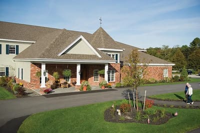 Exterior view of Cape Memory Care with residents walking