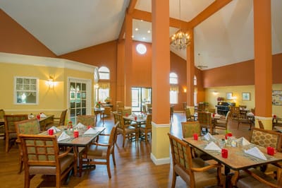 Interior view of a dining room with tables set for a meal