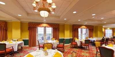 Bright dining room with tables set for meals