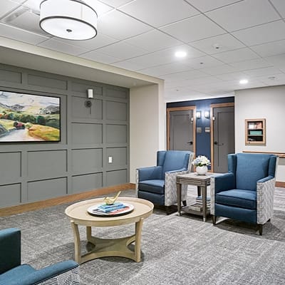 Cozy common area with blue seating and artwork
