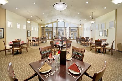 Bright dining room with tables set for residents