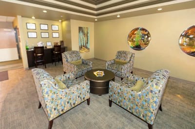A cozy common area with seating and art