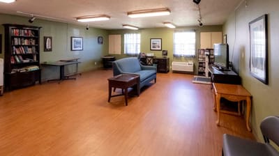 Bright common area with seating and bookshelves