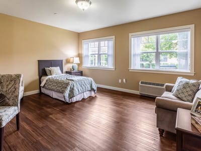 Cozy resident room with a bed and seating area