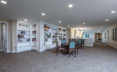Bright common area with bookshelves and dining tables