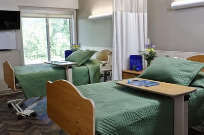 Cozy resident room with two beds and natural light