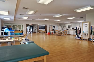 Spacious therapy room with exercise equipment and open area