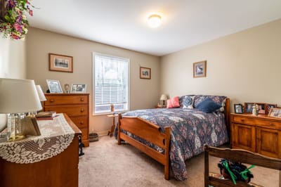 Cozy resident room with a bed and wooden furniture