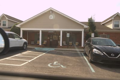 Exterior view of the facility entrance and parking area
