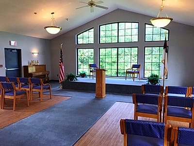 Interior view of a gathering space with seating and windows