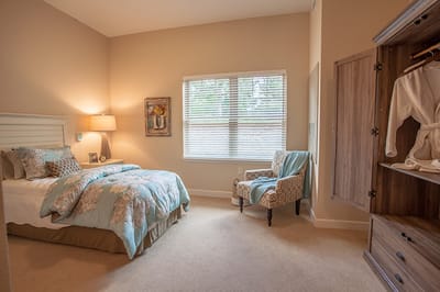 Cozy resident room with bed and seating area