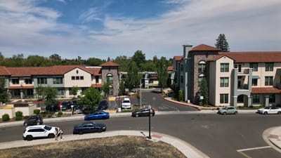 Exterior view of Oakmont of East Sacramento with residents and vehicles