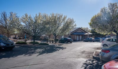 Exterior view of the facility with flowering trees