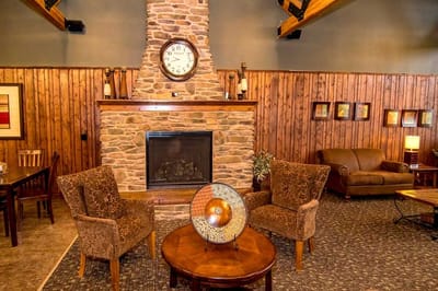 Cozy interior common area with stone fireplace and seating
